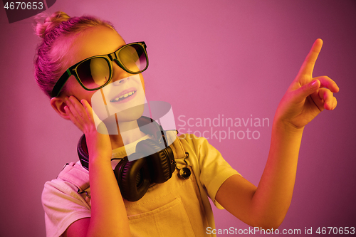 Image of Young girl with headphones enjoying music