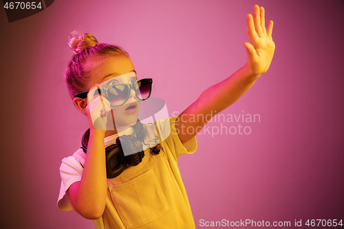 Image of Young girl with headphones enjoying music