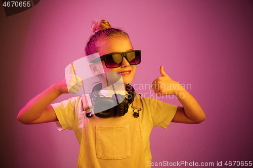 Image of Young girl with headphones enjoying music