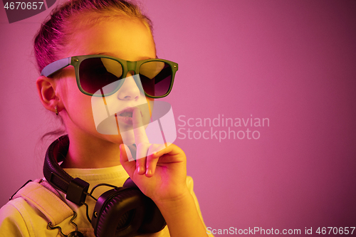Image of Young girl with headphones enjoying music
