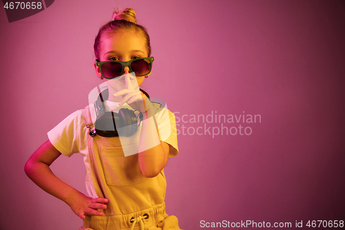 Image of Young girl with headphones enjoying music