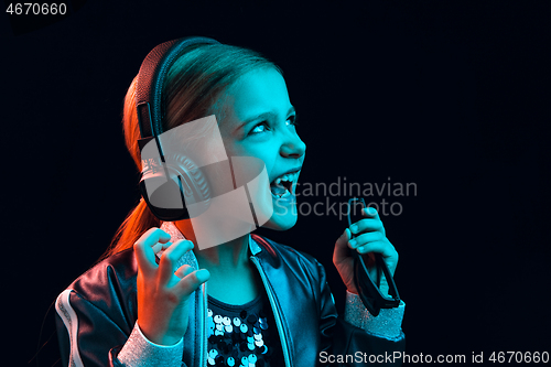 Image of Young girl with headphones enjoying music