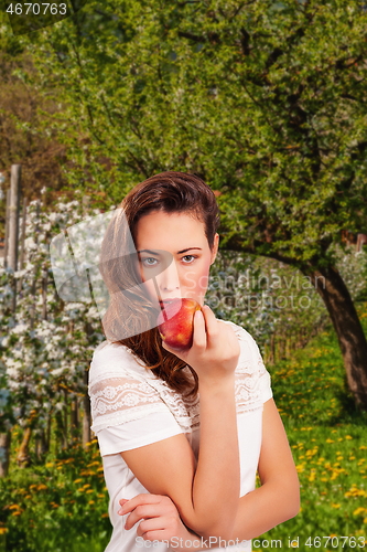 Image of Young woman with apple