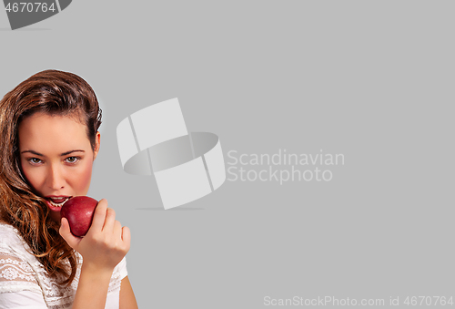 Image of Woman eating a red apple