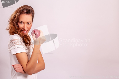 Image of Woman with a red apple in her hand 