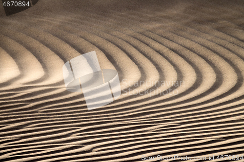 Image of Wind blowing over sand dunes