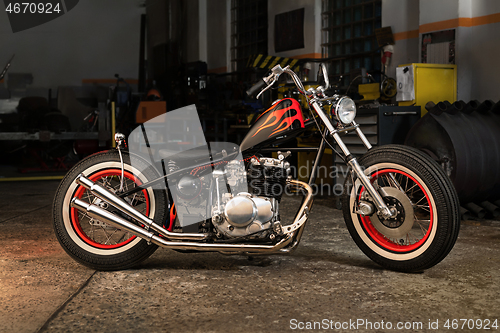 Image of Custom bobber motorbike in an workshop garage.