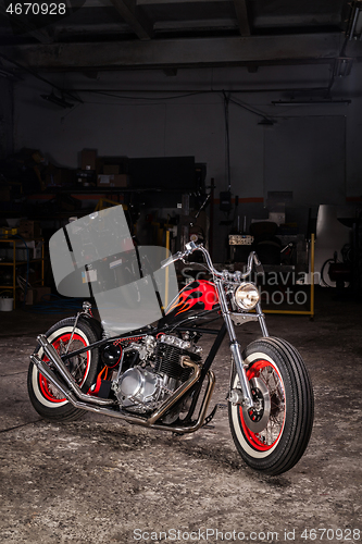 Image of Custom bobber motorbike in an workshop garage.