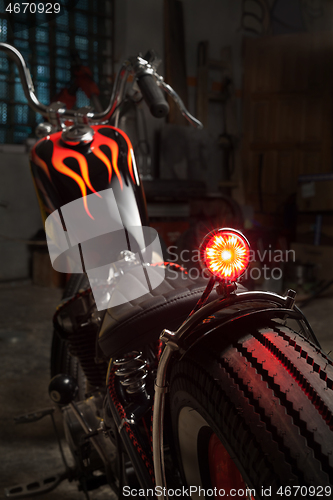 Image of Custom bobber motorbike in an workshop garage.