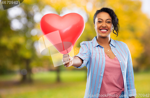 Image of african american woman with heart-shaped balloon