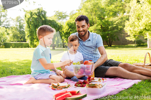 Image of happy family having picnic at summer park