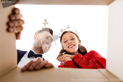 Image of happy couple opening christmas gift box