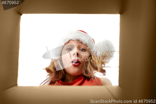 Image of surprised girl looking into christmas gift box