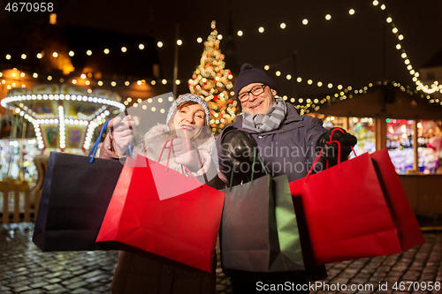 Image of old couple at christmas market with shopping bags