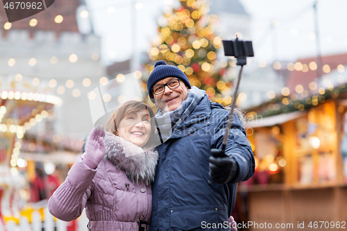 Image of senior couple taking selfie at christmas market