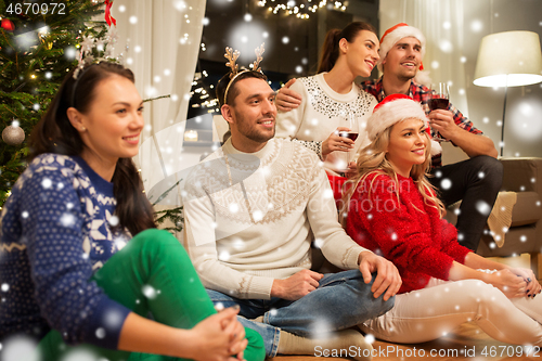 Image of friends celebrating christmas and drinking wine