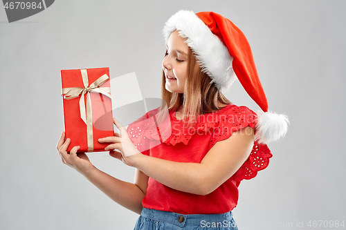 Image of smiling girl in snata hat with christmas gift