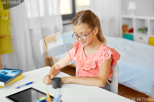 Image of student girl using smart speaker at home