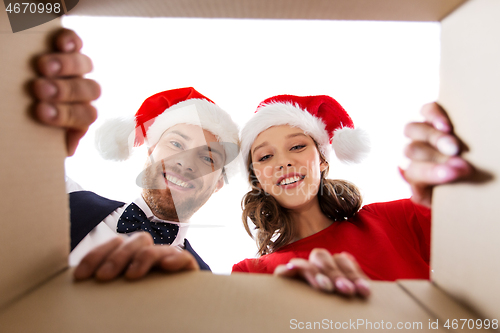 Image of happy couple opening christmas gift box