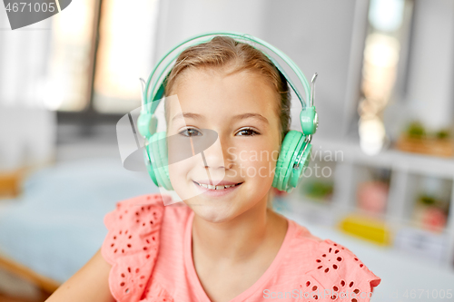 Image of girl in headphones listening to music at home