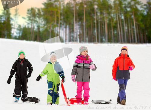 Image of happy little kids with sleds in winter