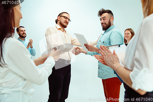 Image of Boss approving and congratulating young successful employee