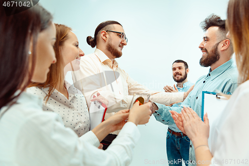 Image of Boss approving and congratulating young successful employee