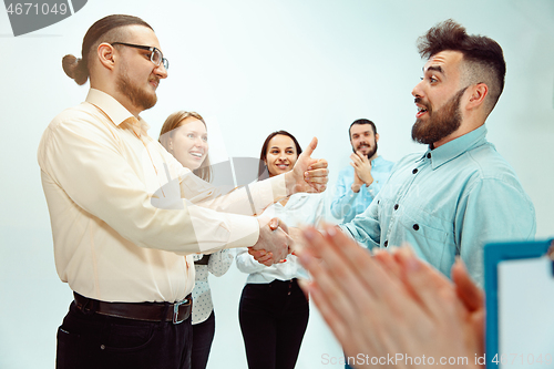 Image of Boss approving and congratulating young successful employee