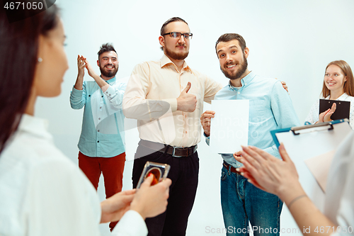 Image of Boss approving and congratulating young successful employee