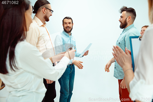 Image of Boss approving and congratulating young successful employee