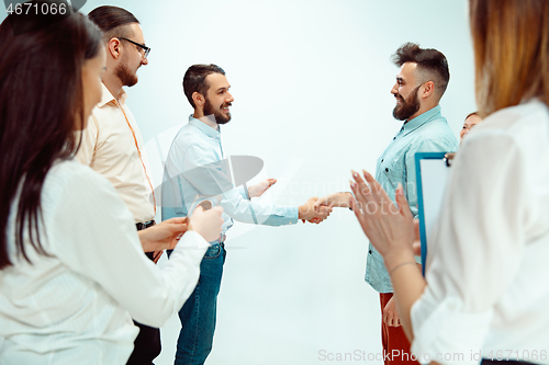 Image of Boss approving and congratulating young successful employee