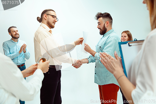 Image of Boss approving and congratulating young successful employee