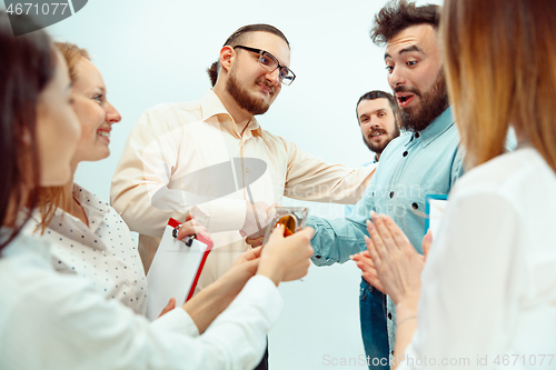 Image of Boss approving and congratulating young successful employee