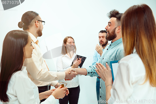 Image of Boss approving and congratulating young successful employee