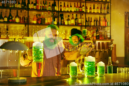 Image of Happy man with glass of beer looking aside in pub