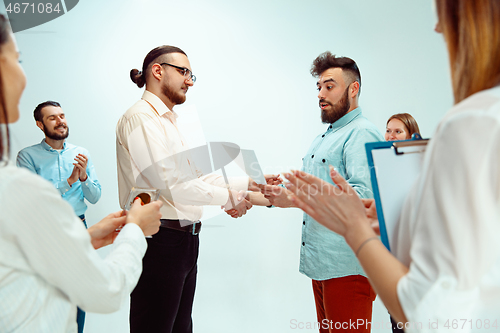 Image of Boss approving and congratulating young successful employee