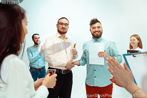 Image of Boss approving and congratulating young successful employee