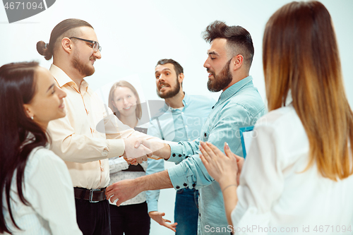 Image of Boss approving and congratulating young successful employee