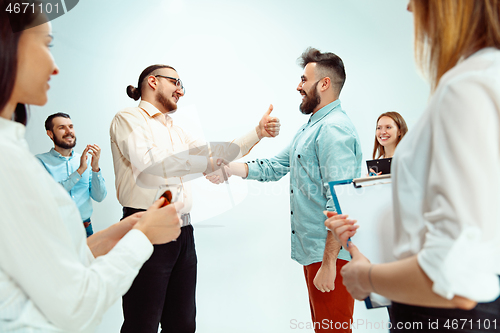 Image of Boss approving and congratulating young successful employee