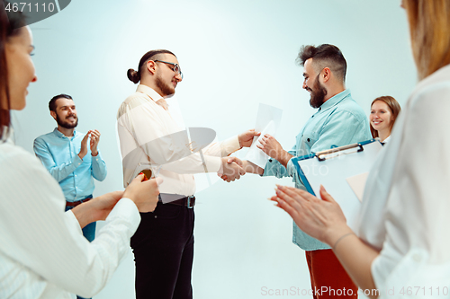 Image of Boss approving and congratulating young successful employee