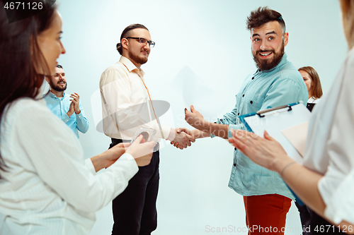 Image of Boss approving and congratulating young successful employee