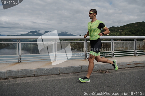 Image of triathlon athlete running on street