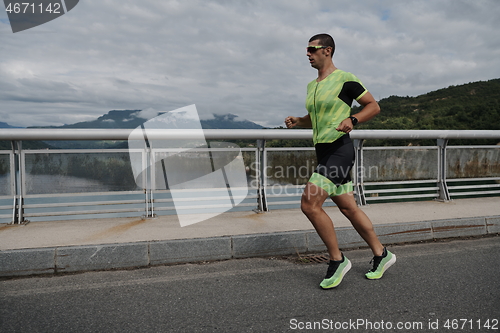 Image of triathlon athlete running on street