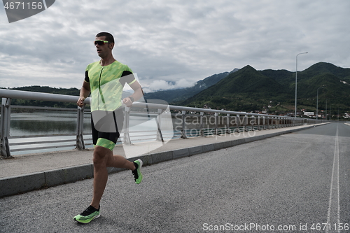 Image of triathlon athlete running on street