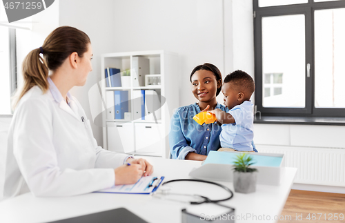 Image of happy mother with baby son and doctor at clinic