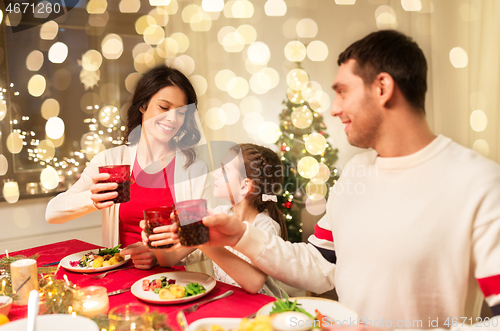 Image of happy family having christmas dinner at home