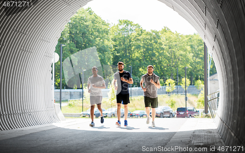 Image of young men or male friends running outdoors