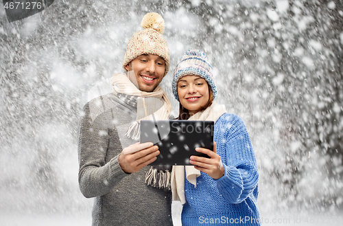 Image of couple in winter clothes with tablet computer