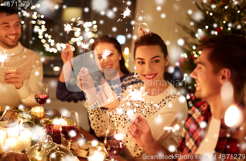 Image of happy friends celebrating christmas at home feast