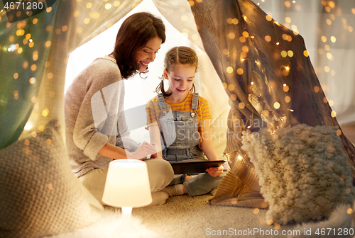 Image of family with tablet pc in kids tent at home